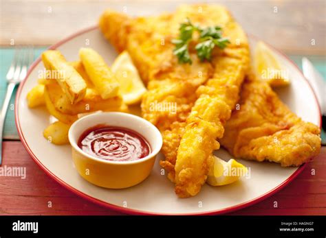 Two Pieces Of Battered Fish On A Plate With Chips Stock Photo Alamy