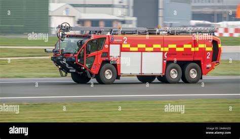 Oshkosh Fire Engine Racing Down The Runway At Manchester Airport Stock