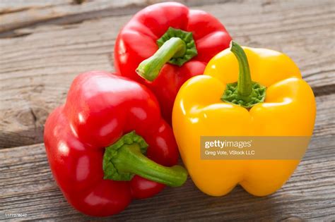Red And Yellow Bell Peppers On Wood High Res Stock Photo Getty Images