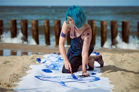 Artistic Blue Haired Woman Performance Artist Smeared With Gouache Paints On Large Canvas On