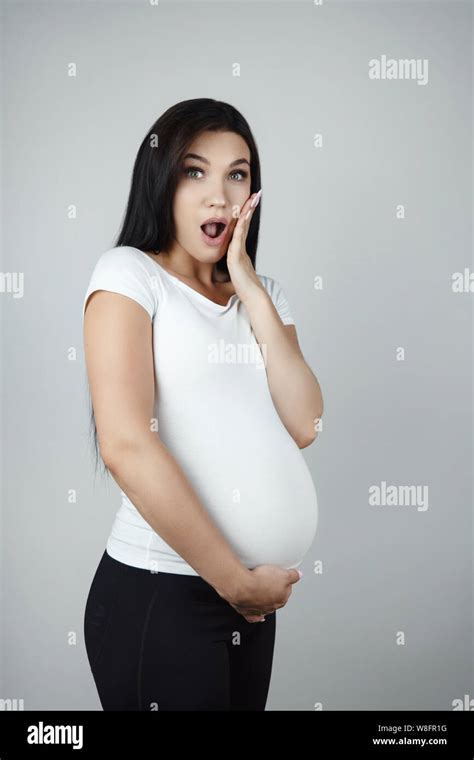 Beautiful Pregnant Brunette Woman Holding Her Pregnant Belly Looking