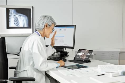 Mature Female Doctor Giving Online Consultation High Res Stock Photo