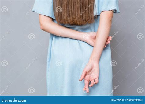 Close Up Of Crossed Fingers Behind Woman S Back Stock Photo Image Of