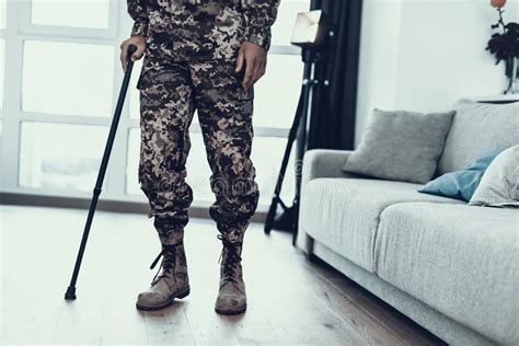 Closeup Soldiers Legs Leaning On Crutch Near Sofa Stock Image Image
