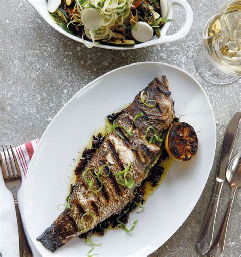 Grilled Whole Black Sea Bass And Vegetables With Charred Red Onion