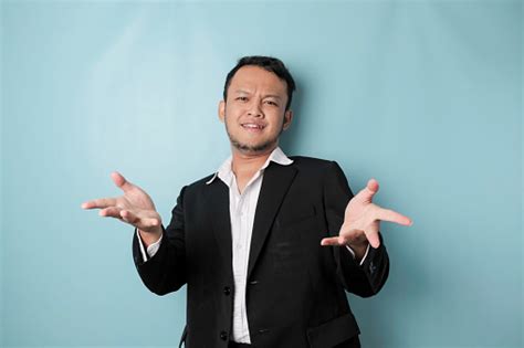 A Portrait Of Asian Businessman Wearing Black Suit Look So Confuse