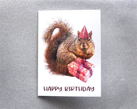 A Happy Birthday Card With A Squirrel Holding A Present