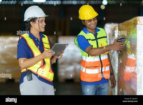 Asian Couple Warehouse Workers Checking Shipment Status On Digital