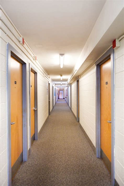 An Empty Hallway With Doors Leading To Another Room On Either Side And