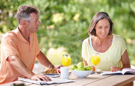 conversation and companionship shot of a mature couple having breakfast together outdoors