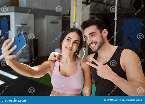 Brunette Fitness Couple Taking A Selfie With Their Phone After