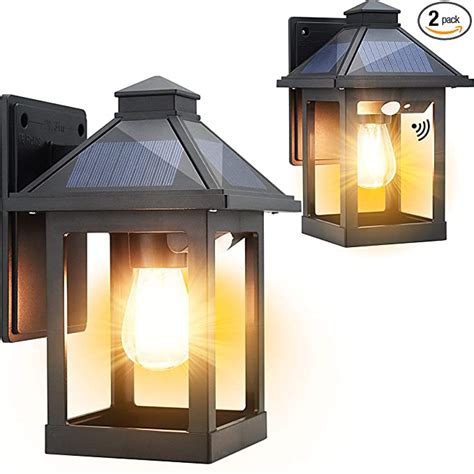 Two Black Outdoor Lights With One Light On Each Side And The Other Off