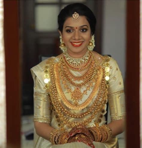 A Woman In A White And Gold Bridal Outfit With Her Hands On Her Hips