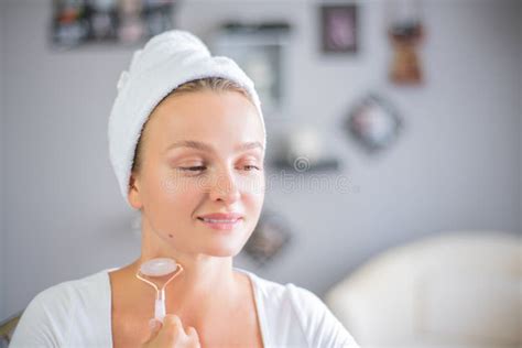 Face Massage Beautiful Woman Is Getting Massage Face Using Jade Facial Roller For Skin Care