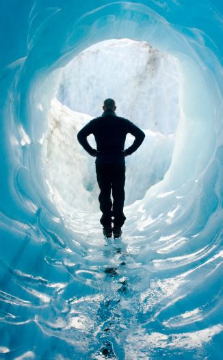 Man Standing In Glacier Ice Cave Stock Photo Download Image Now Ice