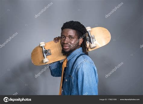 Fashionable African American Man With Skate On Shoulder On Gray — Stock