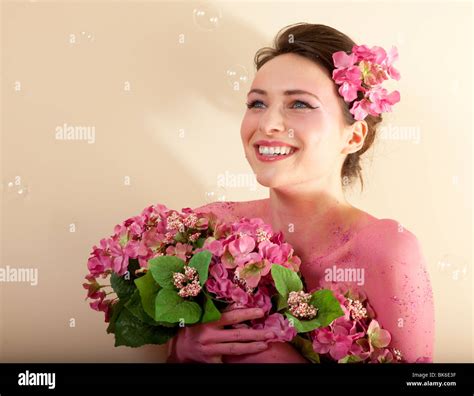 Studio Photo Of Pretty Brunette Woman Holding Bouquet Of Artificial