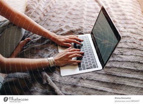 Woman S Hands Typing On Laptop Keyboard In The Cozy Bedroom A