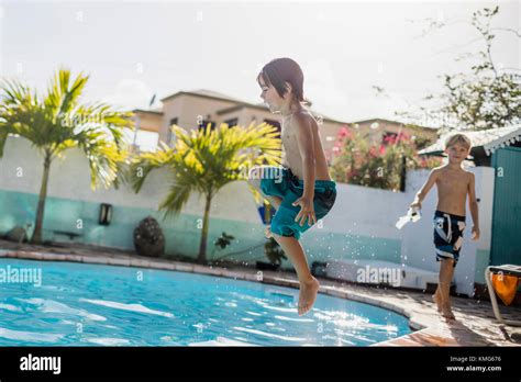 Little Boy Jumping Into The Pool Stock Photo Alamy