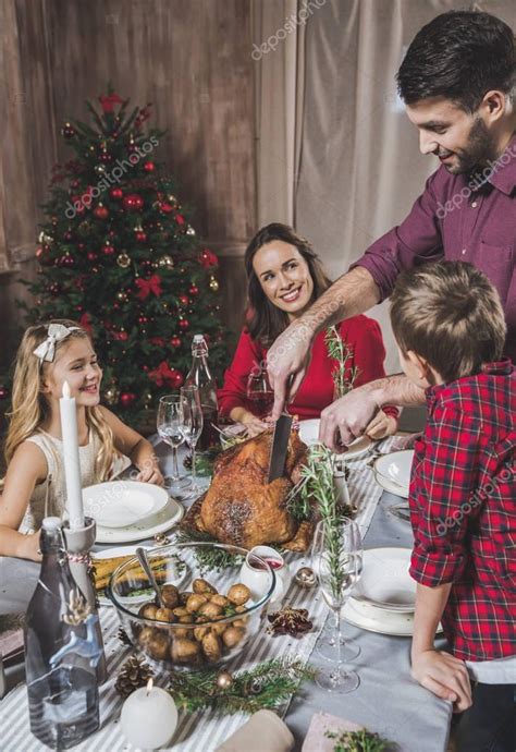 Christmas dinner party games forbidden lingo. Family having Christmas dinner — Stock Photo © ArturVerkhovetskiy #134874564