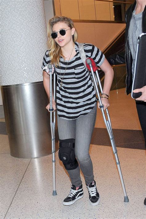 Chloe Moretz Wears Knee Brace And Uses Crutches Lax Airport December