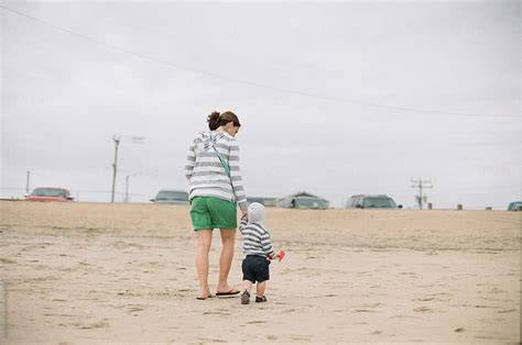 Mother And Son Holding Hands Walking Home From Playing On The Beach By Stocksy Contributor