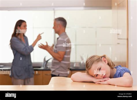 Sad Little Girl Listening Her Parents Having An Argument Stock Photo
