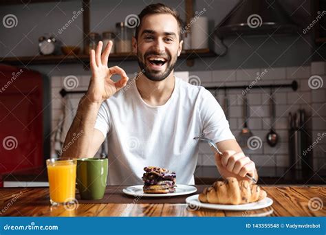 Portrait Of Handsome Man S Eating While Having Breakfast In Stylish