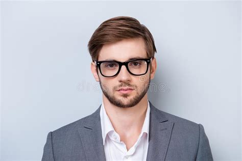 Portrait Of Serious Young Man In Glasses Looking Straight In Cam Stock