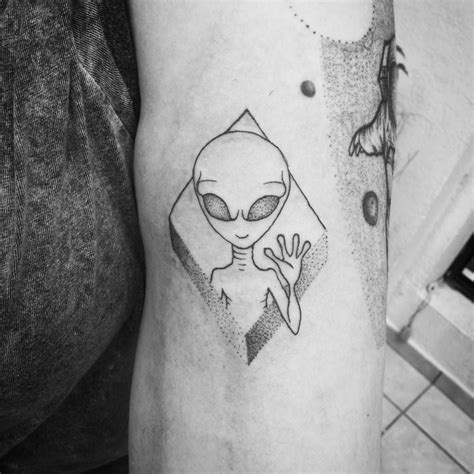A Black And White Photo Of An Alien Tattoo