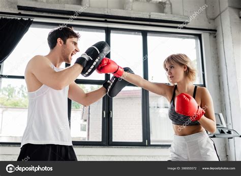 Sportive Girl Boxing Gloves Punching Emotional Man Boxing Pads — Stock