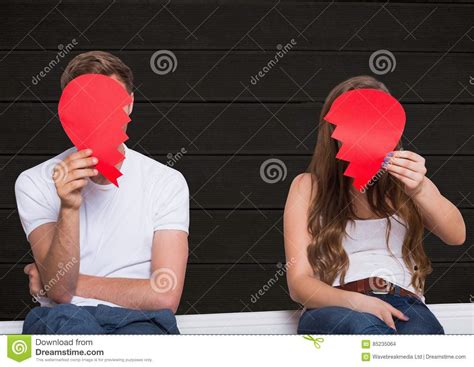Sad Couple Hiding Their Face With Broken Hearts Stock