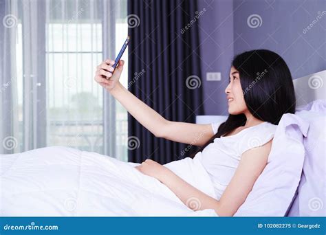 Woman Taking Selfie On Bed In Bedroom Stock Image Image Of Phone Relax 102082275