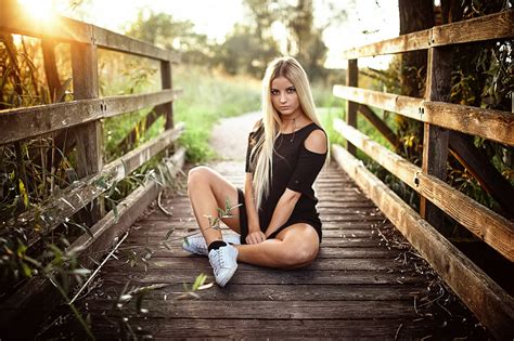 women blonde long hair sitting socks sneakers black dress depth of field trees