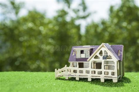 Wooden House On The Background Of Grass And Greens Stock Photo Image