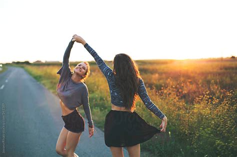 Two Female Friends Dancing On The Road By Jovana Rikalo Stocksy United