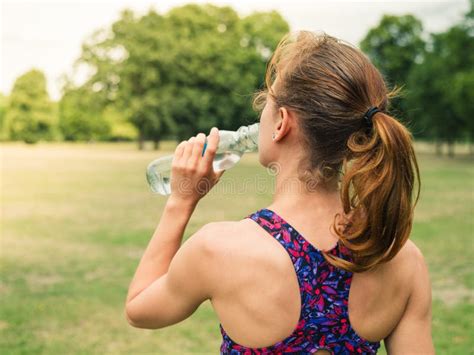 Sporty Woman Drinking From Bottle In Park Stock Photo Image Of Summer