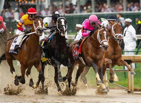 Jockeys Are Racing Their Horses Around The Track