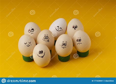 Chicken Eggs With Smileys For Easter Painting On Yellow Background