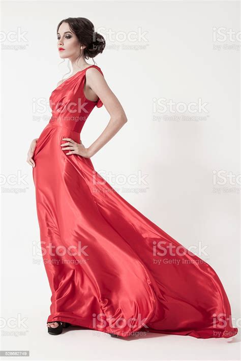 Young Beauty Woman In Fluttering Red Dress White Background Stock Photo