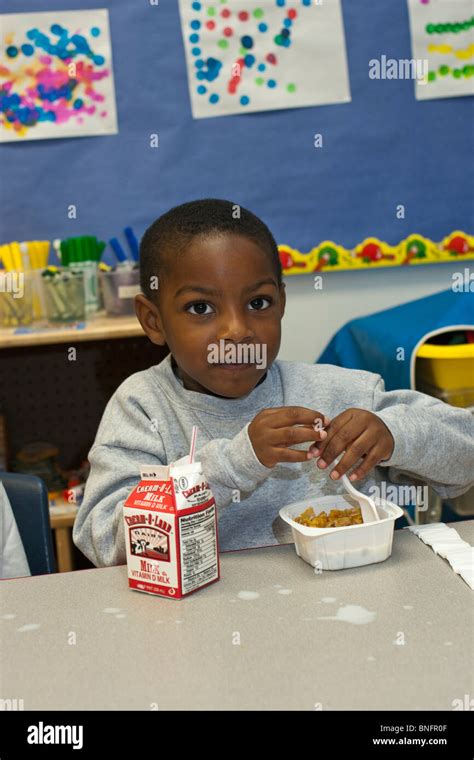 4 Year Old African American Preschool Boy Eating Cereal For Breakfast