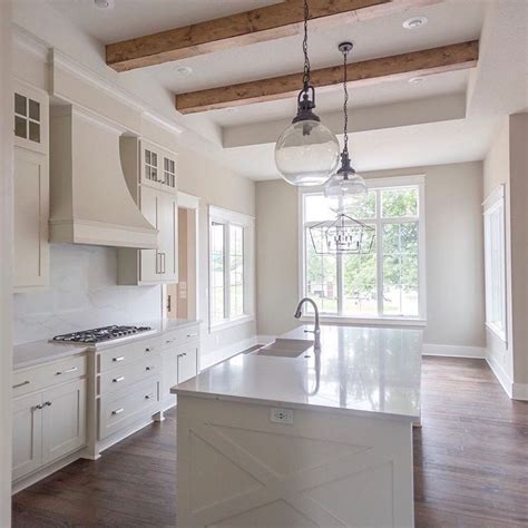 A brilliant, almost sparkling white, this clean shade suggests clarity and simplicity. A warm white kitchen! 🖤 The cabinets are painted a light ...