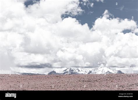 Beautiful Arid Scenery With Snowy Mountains And Cloudy Sky In Salinas