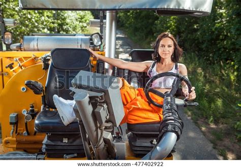 Sexy Woman Orange Overalls Operating Tractor Stock Photo