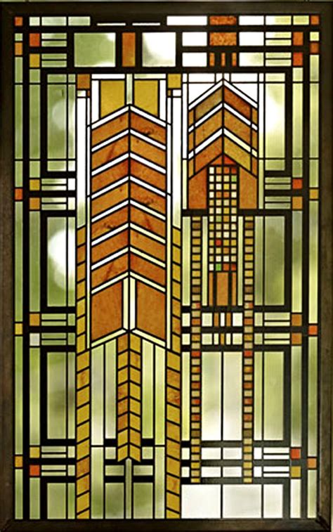A Stained Glass Window With An Arrow Design On The Bottom And Sides In Brown Tones
