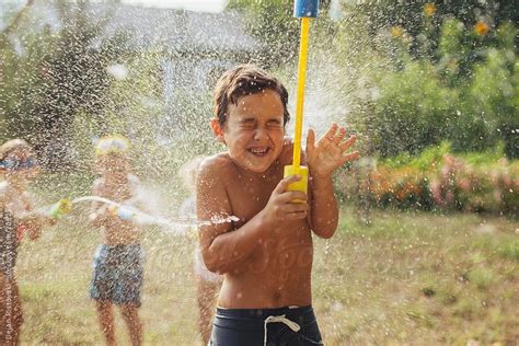 Children Splashing With Water By Dejan Ristovski Stock Photography