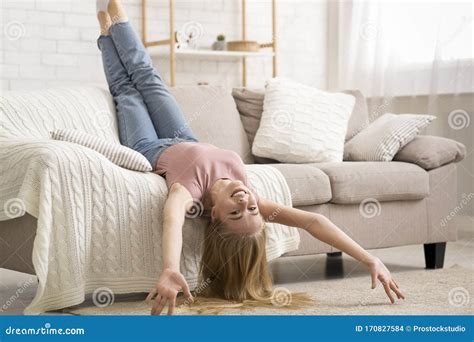 Young Woman Laying Upside Down On Couch At Home Stock Photo Image Of
