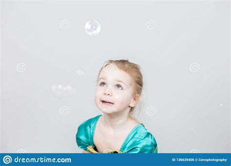 Beautiful Little Blonde Girl Has Happy Fun Cheerful Smiling Face Pink