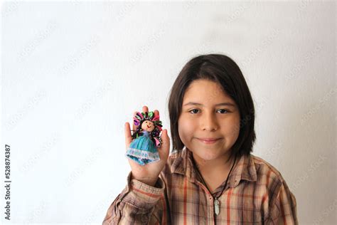 10 Year Old Hispanic Latina Girl Shows Her Favorite Toy And Dessert In The Form Of A Traditional