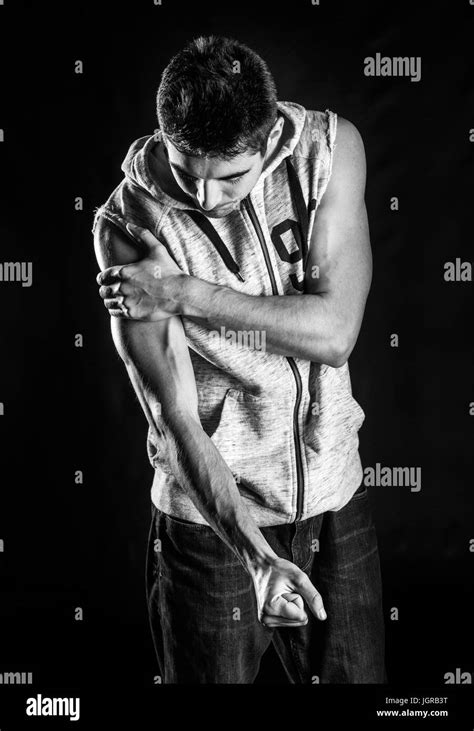 Guy Flexing His Muscle While Looking Black And White Stock Photos